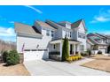 Charming two-story home with a well-manicured lawn, showcasing its architectural design at 345 Somerled Way, Waxhaw, NC 28173
