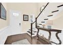 Welcoming foyer with hardwood floors, staircase, and a decorative table, creating an inviting entrance at 345 Somerled Way, Waxhaw, NC 28173