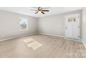 Inviting living room showcasing modern flooring, ample natural light, and a welcoming entry door at 416 E Park Ave, Gastonia, NC 28054