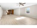 Bright open-plan living room with ceiling fan, hardwood floors and views of the kitchen at 416 E Park Ave, Gastonia, NC 28054