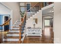 Elegant foyer with hardwood floors, a staircase with decorative runners, and stylish accents at 4231 Brushy Knl, York, SC 29745