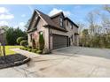 Side view of a two-car garage with a spacious driveway and landscaped surroundings at 4231 Brushy Knl, York, SC 29745
