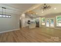 Bright open-concept living space with cathedral ceiling, wood floors, and modern kitchen with center island at 472 Oak Rd # 114/115/116, Norwood, NC 28128
