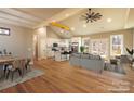 Bright open-concept living space with cathedral ceiling, wood floors, and modern kitchen with center island at 472 Oak Rd # 114/115/116, Norwood, NC 28128