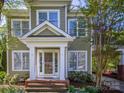 Inviting front entrance with brick steps, white pillars, and a clear view of the home's number at 547 Ashby Dr, Davidson, NC 28036