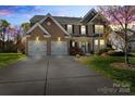 Charming two-story brick home with a two-car garage and well-maintained landscaping at 5854 Crimson Oak Ct, Harrisburg, NC 28075