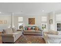 Bright and airy living room featuring neutral colors, comfortable seating, and natural light at 5854 Crimson Oak Ct, Harrisburg, NC 28075