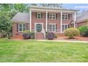 Charming two-story brick home with a well-maintained front yard at 6730 Gold Wagon Ln, Mint Hill, NC 28227