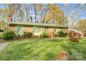 Traditional brick home with a well-manicured front yard and inviting entrance at 7000 David Ave, Charlotte, NC 28214