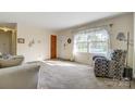 Inviting living room with neutral walls, carpet, and bright natural light at 7000 David Ave, Charlotte, NC 28214
