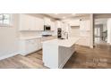 Modern kitchen features a large island, stainless steel appliances, and ample white cabinetry at 7005 New Town Rd, Waxhaw, NC 28173