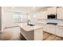Bright kitchen featuring a large island, stainless appliances, and modern white cabinetry at 7005 New Town Rd, Waxhaw, NC 28173