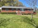 Charming brick home with a well-manicured lawn and colorful shrubbery at 701 Dakota St, Kannapolis, NC 28083