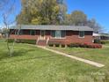 Charming brick home with a well-manicured lawn and colorful shrubbery at 701 Dakota St, Kannapolis, NC 28083