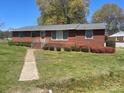 Charming brick home with a well-manicured lawn and colorful shrubbery at 701 Dakota St, Kannapolis, NC 28083