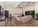 Open living room with hardwood floors, modern furnishings, and a flat screen tv at 7900 Gilead Rd, Huntersville, NC 28078
