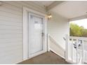 Close up of the condo's entrance, showing the door and railing leading up to it at 9287 Meadow Vista Rd, Charlotte, NC 28213