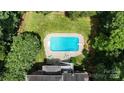 Aerial view of sparkling pool, backyard and brick home surrounded by lush landscaping at 101 Saddletree Rd, Lincolnton, NC 28092