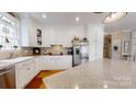 Bright kitchen featuring white cabinetry, granite countertops, stainless steel appliances and hardwood floors at 101 Saddletree Rd, Lincolnton, NC 28092