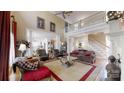 Open concept living area with soaring ceilings, staircase, and a view into the kitchen at 101 Saddletree Rd, Lincolnton, NC 28092