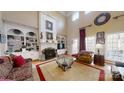 Spacious living room with high ceilings, large windows, a fireplace, and built-in shelving units at 101 Saddletree Rd, Lincolnton, NC 28092