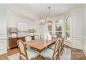 Elegant dining room with hardwood floors, bay windows, and modern chandelier at 1029 Seminole Dr, Waxhaw, NC 28173