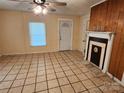 Living room featuring a decorative fireplace and tile flooring at 109 Starnes St, Chester, SC 29706