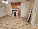 Living room view showcasing fireplace, tile flooring and access to additional rooms at 109 Starnes St, Chester, SC 29706