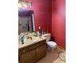 Bathroom with a mirror, toilet, and sink set in a wooden vanity with storage at 1336 Mt Sinai Church Rd, Shelby, NC 28152