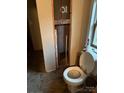 Bathroom with an exposed pipe and toilet with a window letting in natural light at 1336 Mt Sinai Church Rd, Shelby, NC 28152