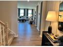 Open-concept living area with hardwood floors, abundant natural light, and a view of the outdoor scenery at 1468 Honey Trl, Monroe, NC 28112