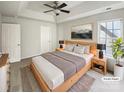 Comfortable bedroom featuring a tray ceiling, a ceiling fan, and natural light at 15188 Eric Kyle Dr, Huntersville, NC 28078