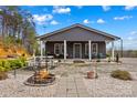 Back exterior features a fire pit, patio with ample seating, and a well-maintained stone walkway at 1595 Cheatham Ford Rd, Hiddenite, NC 28636