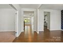 Open-concept entryway with gleaming hardwood floors, and easy access to the living room and kitchen at 20422 Creek Bend Edge Ct, Matthews, NC 28105