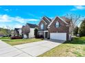 Beautiful two-story brick home with a manicured lawn, two car garage and inviting curb appeal at 2275 Laurens Dr, Concord, NC 28027