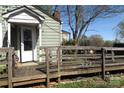 Close-up of the charming cottage-style home with a wooden porch, accessible ramp, and easy access to the front door at 2547 Gastonia Hwy, Lincolnton, NC 28092
