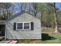 Exterior shot of a cottage-style home, highlighting the vintage windows and simple architectural details at 2547 Gastonia Hwy, Lincolnton, NC 28092