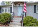 Inviting home exterior features a light blue front door with brick steps and wrought iron railings at 2617 Brookwood Rd, Lincolnton, NC 28092