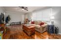 Cozy living room features hardwood floors, a ceiling fan, and a comfortable sofa with stylish decor at 2617 Brookwood Rd, Lincolnton, NC 28092