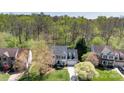 Overhead view of a gray two-story home nestled amongst lush greenery and mature trees at 2815 Providence Spring Ln, Charlotte, NC 28270