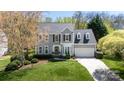 Beautiful two-story home boasts a well-maintained lawn, mature trees, and a side-entry garage at 2815 Providence Spring Ln, Charlotte, NC 28270