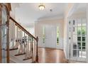 Spacious foyer with hardwood floors and staircase, bathed in natural light, offers a welcoming entrance at 301 Prairie Rose Ct, Waxhaw, NC 28173