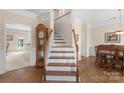 Inviting foyer showcases hardwood floors, staircase with wood handrail, and a glimpse of the adjacent dining room at 301 Prairie Rose Ct, Waxhaw, NC 28173