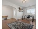Office space showcasing hardwood floors, modern decor, and abundant natural light from a large window at 3036 Whipcord Dr, Waxhaw, NC 28173