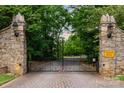 Stone gate entrance to a private community surrounded by lush greenery at 325 Ivy Arbor Cir, Rock Hill, SC 29732