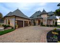 Beautiful home featuring stone accents, a spacious three-car garage, and an inviting driveway at 325 Ivy Arbor Cir, Rock Hill, SC 29732