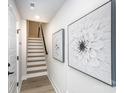 Bright hallway features neutral walls, staircase, and decorative wall art enhancing the inviting ambiance at 3526 Saker Ln, Charlotte, NC 28211