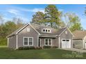 Single-Gathering home with a grey exterior, manicured lawn, and a one-car garage on a sunny day at 3708 Small Ave, Charlotte, NC 28269