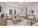 Bright and airy living room with modern decor, neutral colors, and large windows with wood flooring at 3708 Small Ave, Charlotte, NC 28269