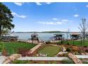 Lush backyard with putting green, manicured lawn, and lake access, ideal for outdoor enjoyment at 3988 Channel Point Ln, Denver, NC 28037
